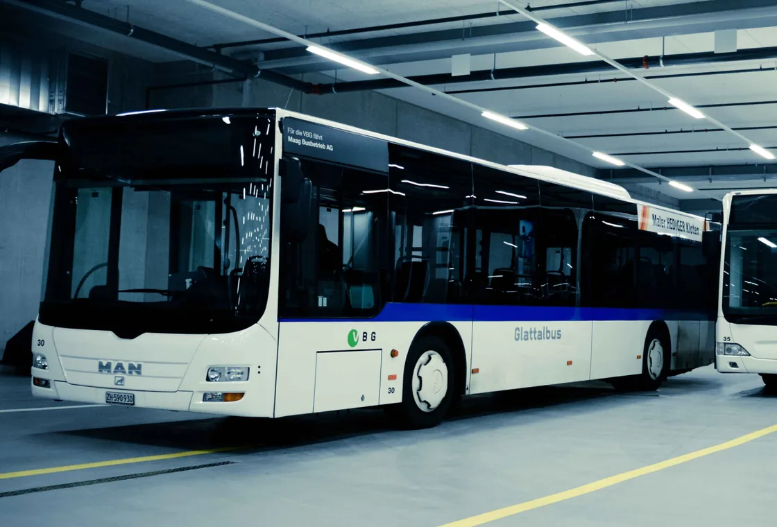 Buses parked in a bright depot