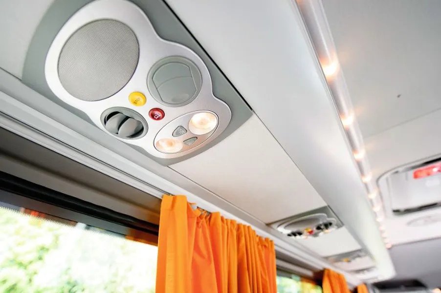 Reading lights and air vents above the seats in the minibus