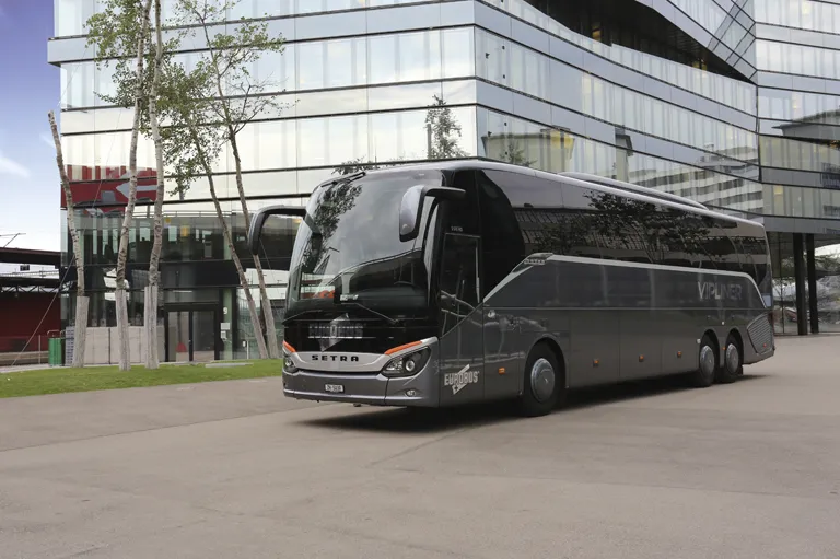 A dark grey VIPLINER parked in front of a glass building