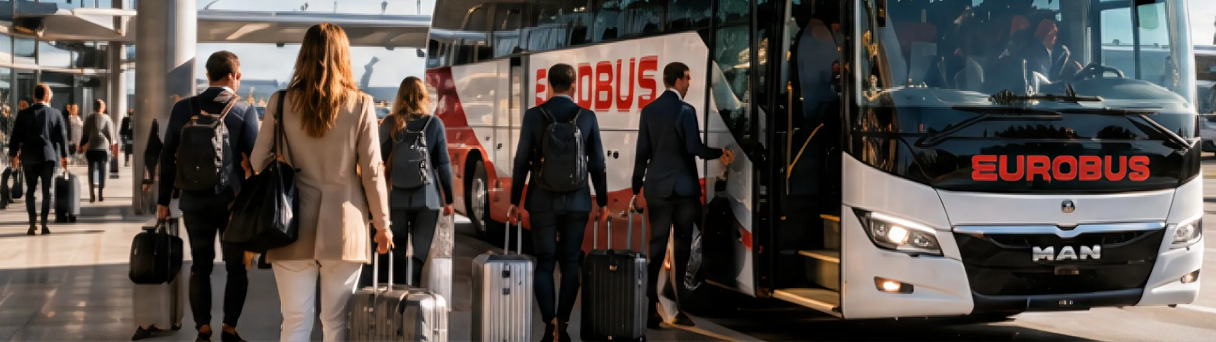 Travellers with suitcases walk towards a EUROBUS coach at an airport