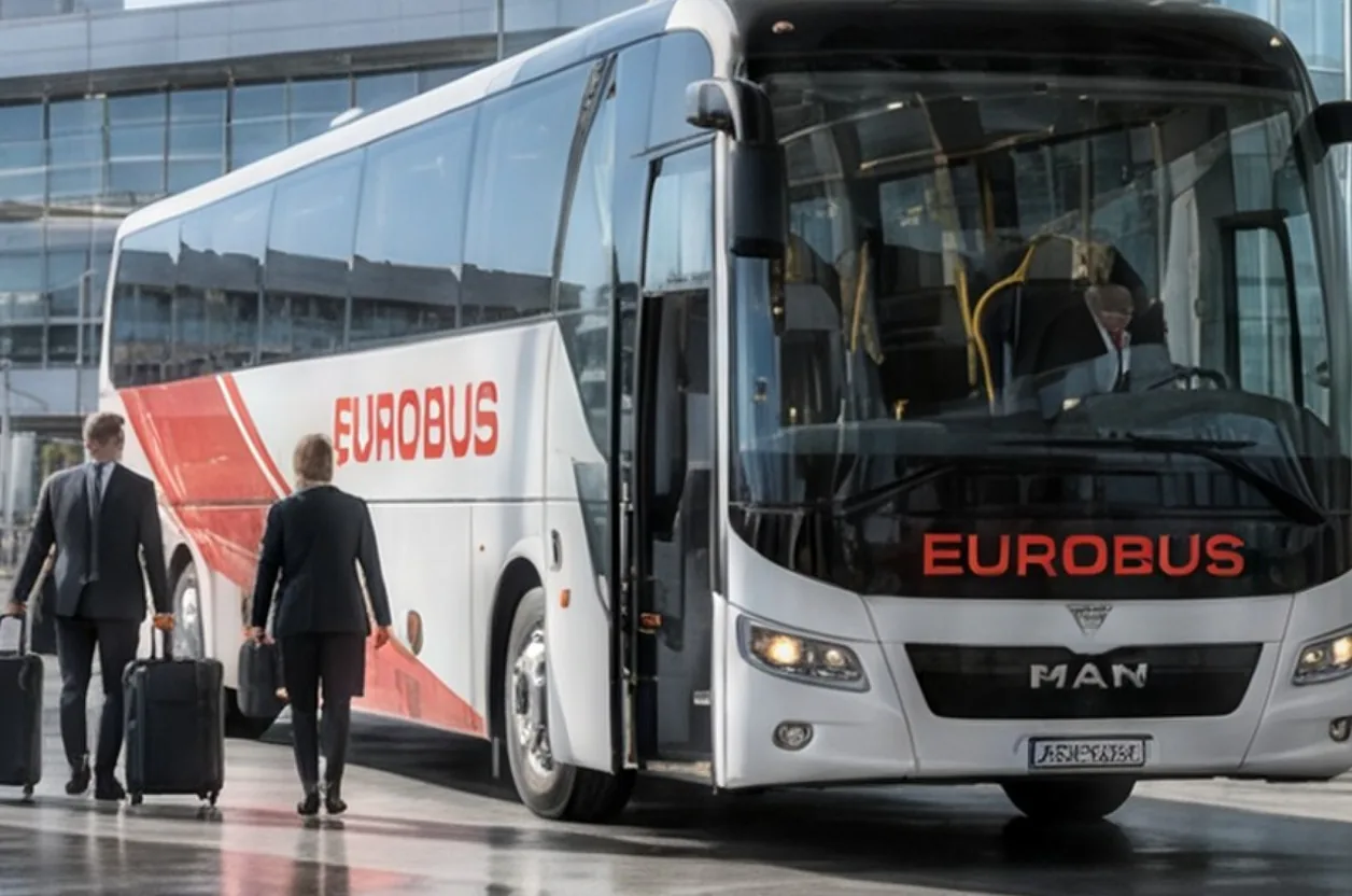 Travellers with suitcases walk towards a EUROBUS coach